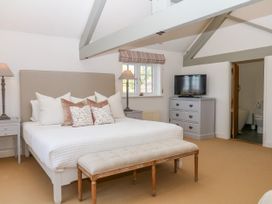 A bedroom with a bed and television at Apple Mill Venn Ottery near Sidmouth