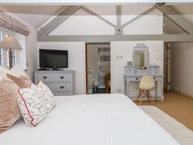 A bedroom with a bed and TV at Apple Mill in Venn Ottery near Sidmouth