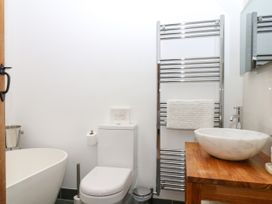 A bathroom with a toilet, bathtub, and hand basin at Apple Mill in Venn Ottery near Sidmouth