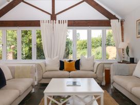 A living room with sofas and a coffee table at Apple Mill in Venn Ottery near Sidmouth