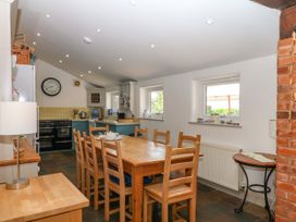 A kitchen with a dining table and chairs at Apple Mill in Venn Ottery near Sidmouth