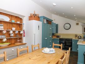 A kitchen with a table and chairs at Apple Mill Venn Ottery near Sidmouth