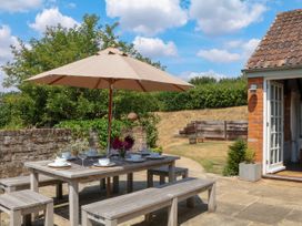 An outdoor dining table with umbrella at Apple Mill Venn Ottery near Sidmouth