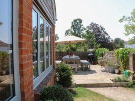 A garden with a table and umbrella at Apple Mill in Venn Ottery near Sidmouth