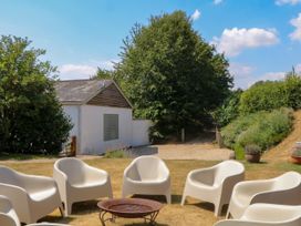 An outdoor area with chairs and a fire pit at Apple Mill in Venn Ottery near Sidmouth