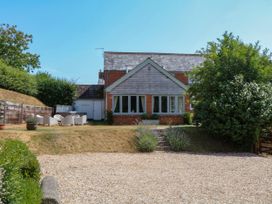 A house with patio furniture and a garden at Apple Mill Venn Ottery near Sidmouth