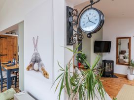 A living room with a clock and rabbit print at Burlodge Swimbridge near Barnstaple