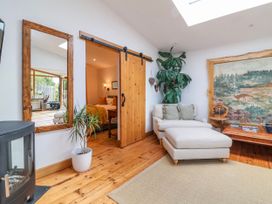 A living room with a sliding door and a plant at Burlodge Swimbridge near Barnstaple