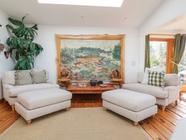 A living room with seating and a wall tapestry at Burlodge in Swimbridge near Barnstaple