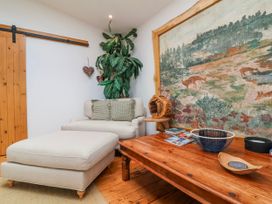 A sitting room with a coffee table and large wall art at Burlodge Swimbridge near Barnstaple