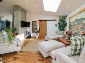 A living room with a sofa and television at Burlodge in Swimbridge near Barnstaple