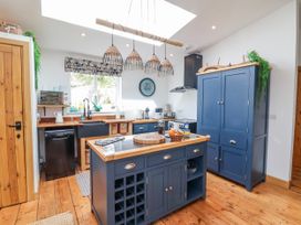 A kitchen with an island and appliances at Burlodge Swimbridge near Barnstaple