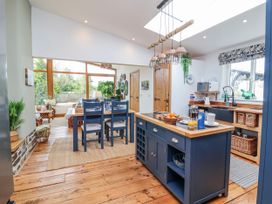 A kitchen with a dining table and chairs at Burlodge, Swimbridge near Barnstaple