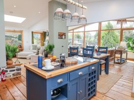 A kitchen with an island and seating at Burlodge in Swimbridge near Barnstaple