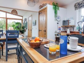 A kitchen with a table and chairs in Burlodge Swimbridge near Barnstaple