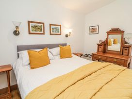 A bedroom with a bed and dresser at Burlodge Swimbridge near Barnstaple