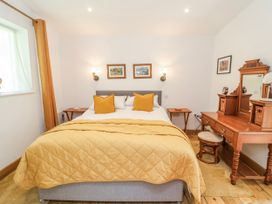A bedroom with a bed and dressing table at Burlodge Swimbridge near Barnstaple