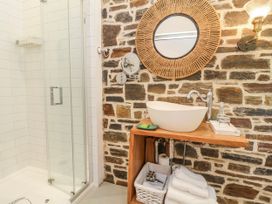 A bathroom with a shower and sink at Burlodge Swimbridge near Barnstaple