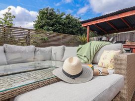 An outdoor seating area with a couch and a coffee table at Burlodge Swimbridge near Barnstaple
