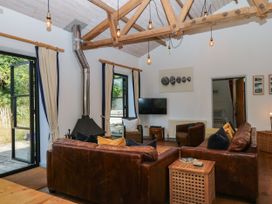 A living room with a television and fireplace at Burrows in Venn Ottery near Sidmouth