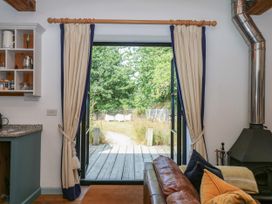 A living room with a view of a garden path at Burrows in Venn Ottery near Sidmouth