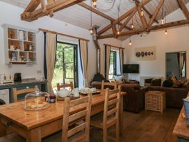 A kitchen with a dining table and chairs at Burrows in Venn Ottery near Sidmouth