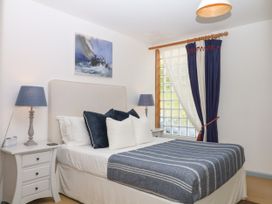A bedroom with a bed and bedside table at Burrows in Venn Ottery near Sidmouth