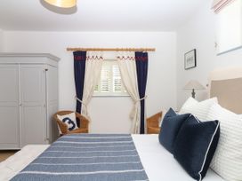 A bedroom with a bed and wardrobe at Burrows Venn Ottery near Sidmouth