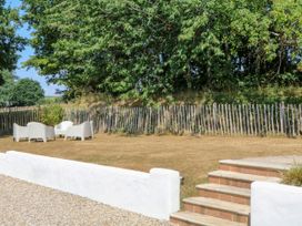 A garden with chairs and a fence at Burrows Venn Ottery near Sidmouth