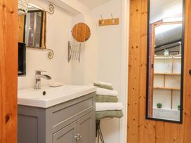 A bathroom with a sink and towels at Sunset Cottage Swimbridge near Barnstaple