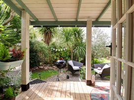 A garden with outdoor furniture and a barbecue at Sunset Cottage Swimbridge near Barnstaple