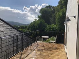 A balcony with a table and chairs at Worthy Barn in Porlock Weir