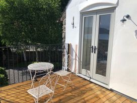 A balcony with a table and chairs at Worthy Barn Porlock Weir