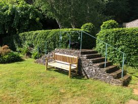 A bench and steps in a garden at Worthy Barn Porlock Weir