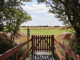 A gate leading to a grassy field at Waverley Cottage in Kilnsea near Easington, Hull