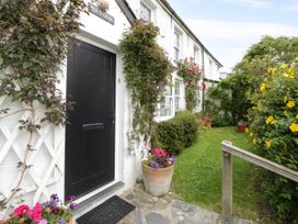 An entrance doorway with flower pots and plants at Pen y Graig in Aberporth