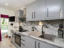 A kitchen with modern appliances and countertop at Squirrels Lodge in South Molton
