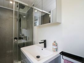 A bathroom with a sink and shower at Squirrels Lodge in South Molton