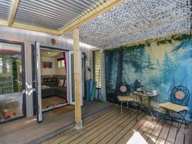An outdoor seating area with a table and chairs at Squirrels Lodge South Molton