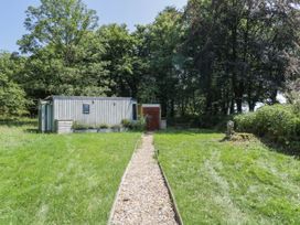 An outdoor view of a building with a pathway at Squirrels Lodge in South Molton