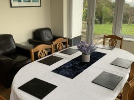 A dining room with a table and chairs at Woods Cottage in Usk
