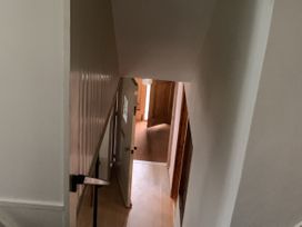 A staircase leading into a hallway at Woods Cottage in Usk