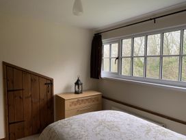 A bedroom with a bed and a window at Woods Cottage Usk