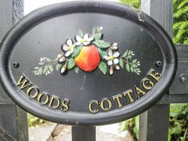 A sign with the text Woods Cottage at Woods Cottage Kingcoed near Raglan