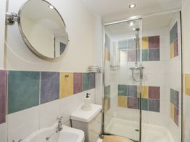 A bathroom with a shower and sink at Woods Cottage Kingcoed near Raglan