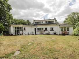 A house with a garden and seating area at Woods Cottage in Kingcoed near Raglan