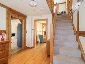 A hallway with wooden floors stairs and doorways leading to other rooms at Cuckoo Pen Cottage Eastham near Tenbury Wells