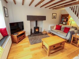 A living room with a fireplace and sofa at Byways in Ambleside
