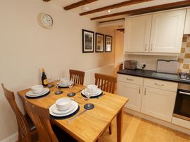 A dining room with a table set for meals at Byways Ambleside