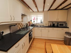 A kitchen with cabinets, stove and sink at Byways in Ambleside